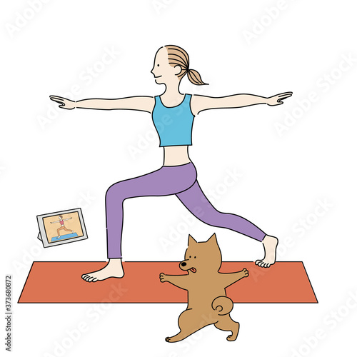 オンラインでヨガのレッスンを受ける女性と犬