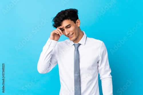 Young Argentinian businessman over isolated blue background laughing