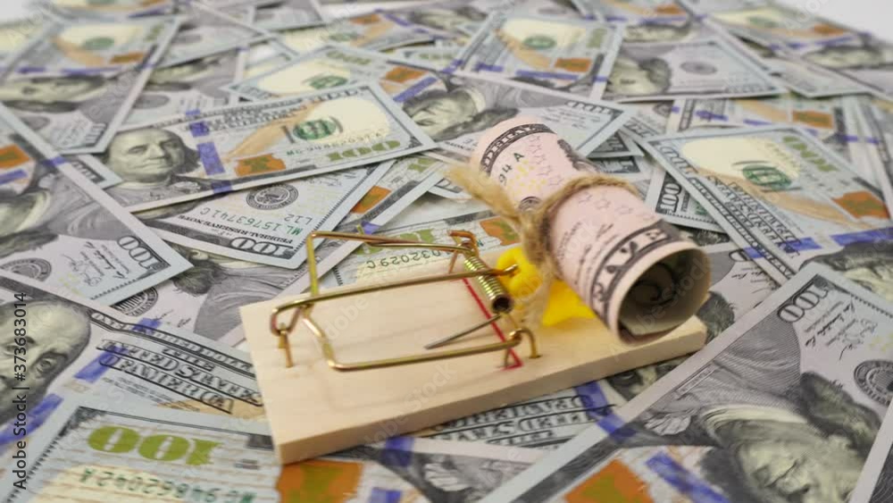 Dollar bill as a bait in a mousetrap. Money is like bait. Cheating, fraud and easy money concept. Free easy money in a mousetrap. Money background, blank mockup, place for text. Dollar bill as a bait in a mousetrap. Money is like bait. Cheating, fraud and easy money concept. Free easy money in a mousetrap. Money background, blank mockup, place for text.