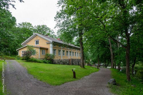 A rural road and a house in the Fiskars village in the summer time.