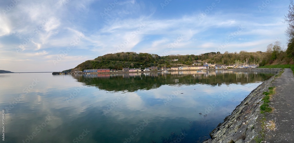 Obraz premium fishing harbour reflecting in a very still sea