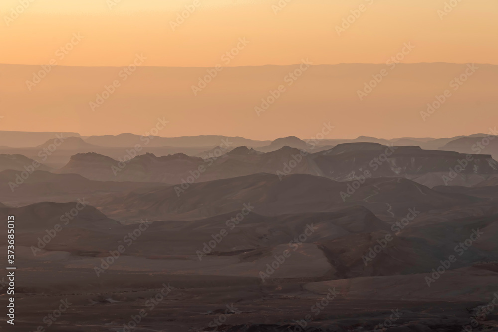 Ranges of Ramon Crater in the Negev Desert in the early morning in fog. Israel