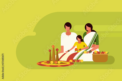 Traditionally dressed family do floral designs on floor during the Onam festival in Kerala