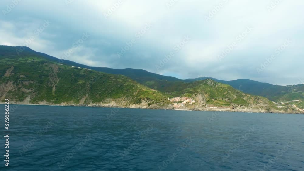 Manarola view from sailing boat floating in the sea water Manarola view from sailing boat floating in the sea water