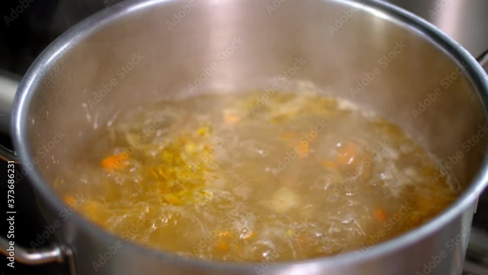 Cooking. close-up. broth is boiling in a saucepan, steam is coming. health food and safety concept. reopening canteen Cooking. close-up. broth is boiling in a saucepan, steam is coming. health food and safety concept. reopening canteen