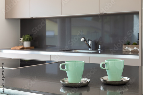 Detail of two breakfast cups in a modern and design kitchen