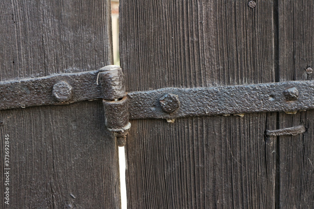 Metal hinges on wooden doors