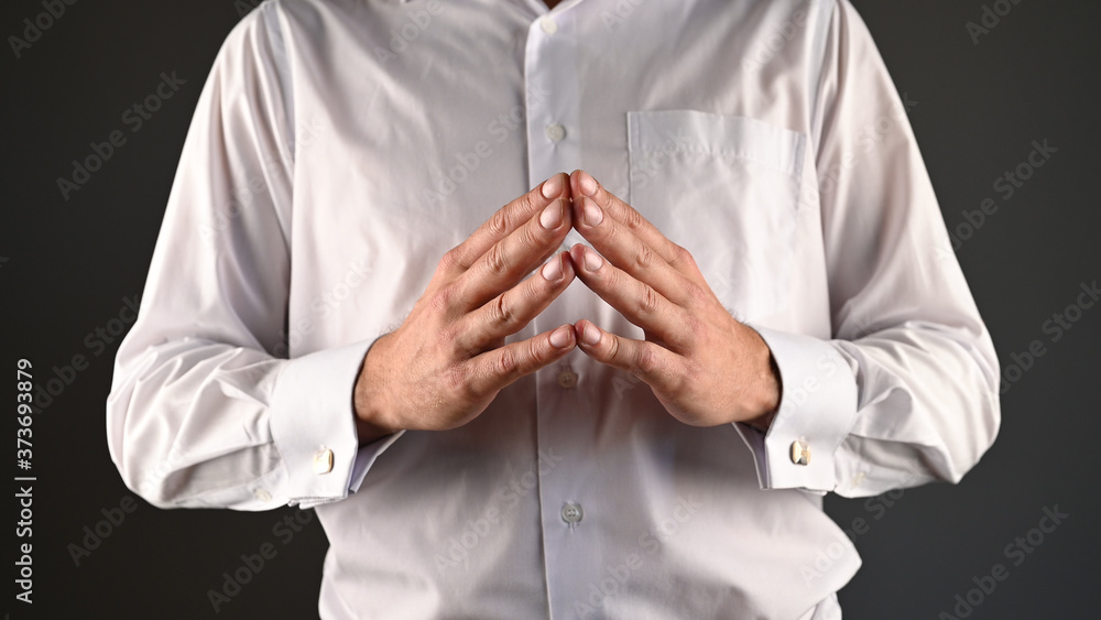 a man in a white shirt expresses help with his hands