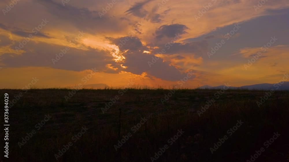 4K clip of Sunset over a grain field in Drama, Greece 4K clip of Sunset over a grain field in Drama, Greece
