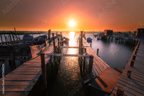 Sunset at Carrasqueira's palafitic sea port. A traditional maritime port for local fishermen. photo