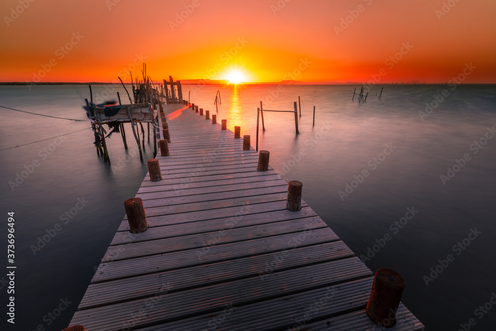 Fototapeta premium Sunset at Carrasqueira's palafitic sea port. A traditional maritime port for local fishermen.