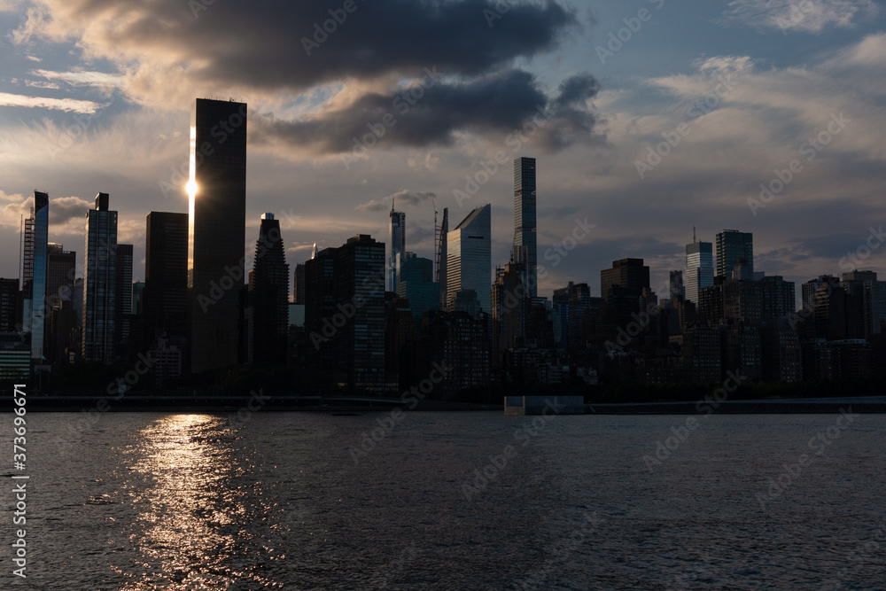 Beautiful Silhouettes of Skyscrapers in the Midtown Manhattan Skyline during a Sunset along the East River in New York City