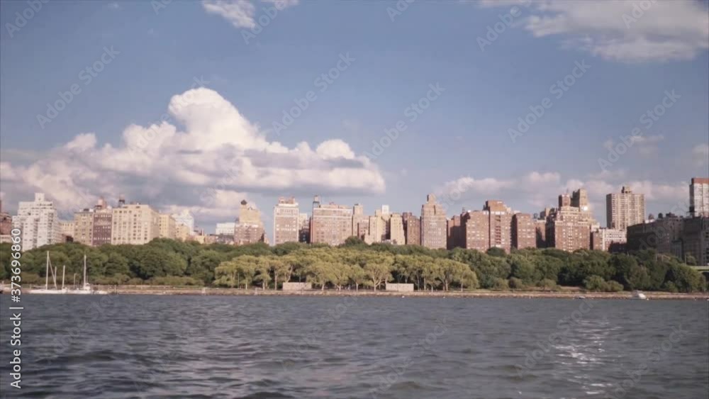View of Manhattan Islands in New York from the side of a pleasure boat sailing in the Hudson River. Brooklyn perspective. New York East River. Steamer on the river. Boat sailing in the Hudson River View of Manhattan Islands in New York from the side of a pleasure boat sailing in the Hudson River. Brooklyn perspective. New York East River. Steamer on the river. Boat sailing in the Hudson River