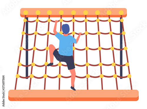 Little boy climbing at rope wall or net wall. Sports activity. Energy child spending time and have fun at sports playground isolated at white. Kid climb at rope net, barrier. Boy view from back side