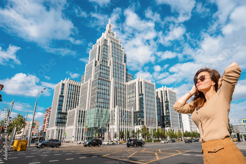 Photography Moscow / Russia - 16 Aug 2020: A young woman stands at a busy automobile interse