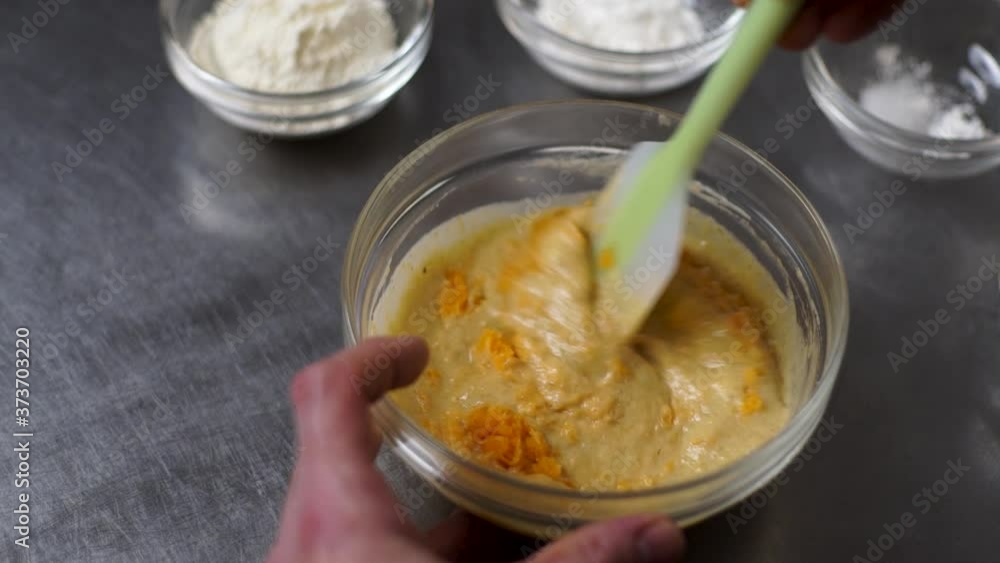 Making orange pudding, mixing ingredients in a bowl in slow motion. Making orange pudding, mixing ingredients in a bowl in slow motion.