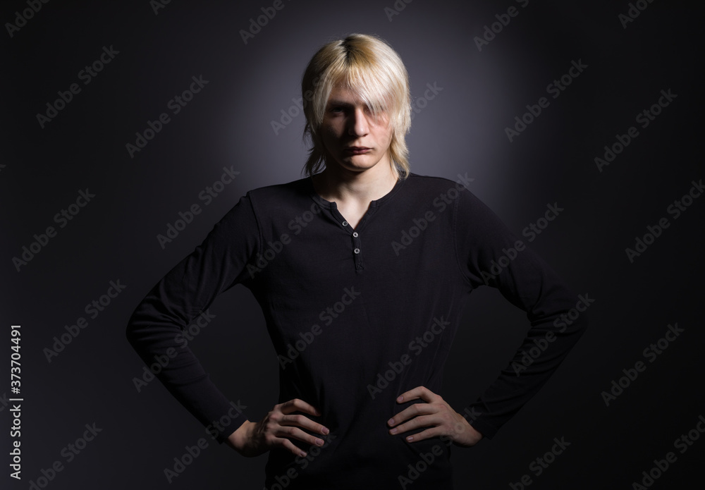 Portrait of a young stylish man with white hair on a black background. Portrait of a young stylish man with white hair on a black background.