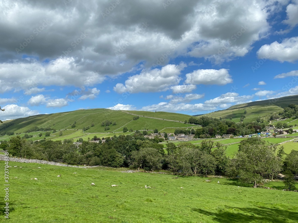 Landscape view, looking toward Kettlewell, with fields, trees, and hills near, Kettlewell, Skipton, UK