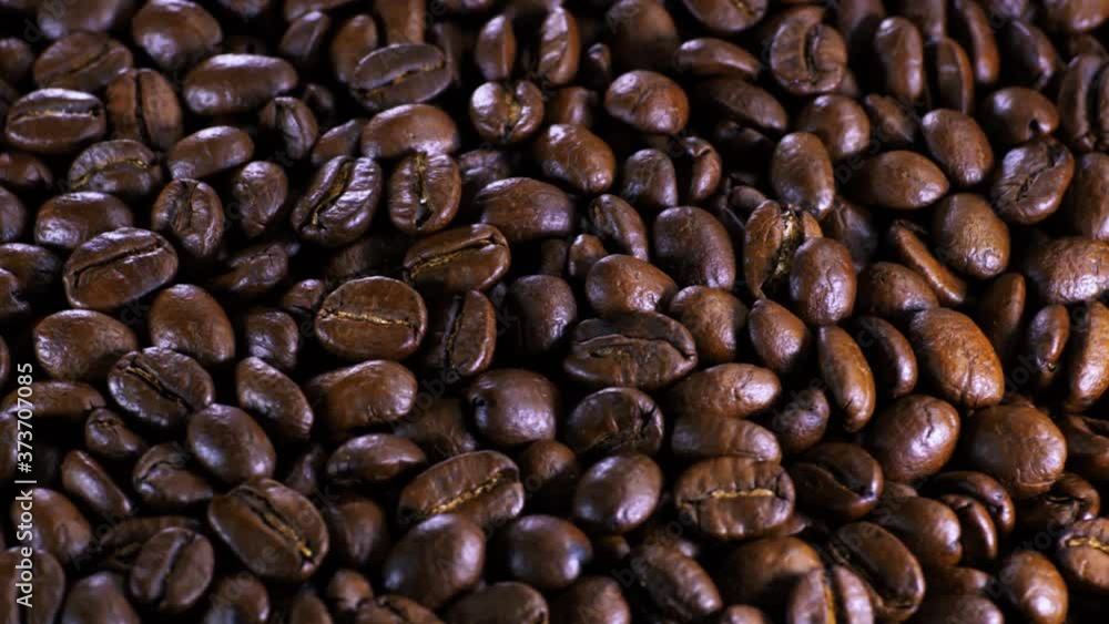 Roasted coffee bean. Fragrant coffee beans scrolls slowly around the camera. Slow Motion Close Up of Whole Roasted Coffee Beans. Roasted coffee bean. Fragrant coffee beans scrolls slowly around the camera. Slow Motion Close Up of Whole Roasted Coffee Beans.