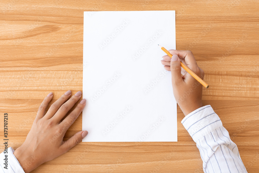 Woman hand writing on blank paper sheet A4 size Woman hand writing on blank paper sheet A4 size