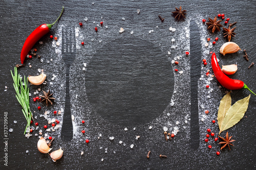 Fototapeta Naklejka Na Ścianę i Meble -  Various herbs and spices on dark stone table.