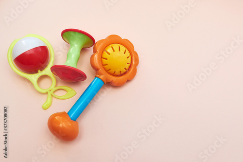Plastic Retro Rattle. Baby toys on pink background. Flat lay. Copy space.