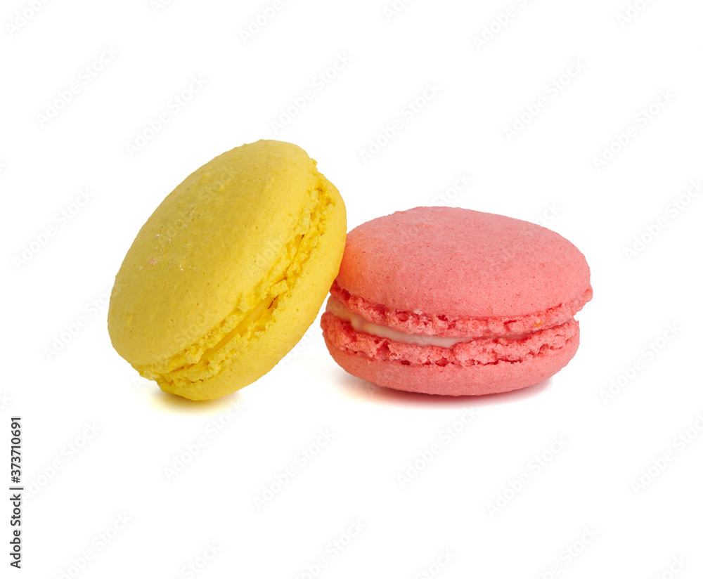 yellow and pink round baked macarons isolated on a white background yellow and pink round baked macarons isolated on a white background