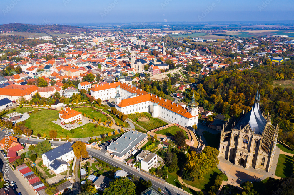 Panoramic view from drone of Czech town of Kutna Hora overlooking medieval Jesuit College and St. Barbara Cathedral on sunny autumn day, Central Bohemian Region..