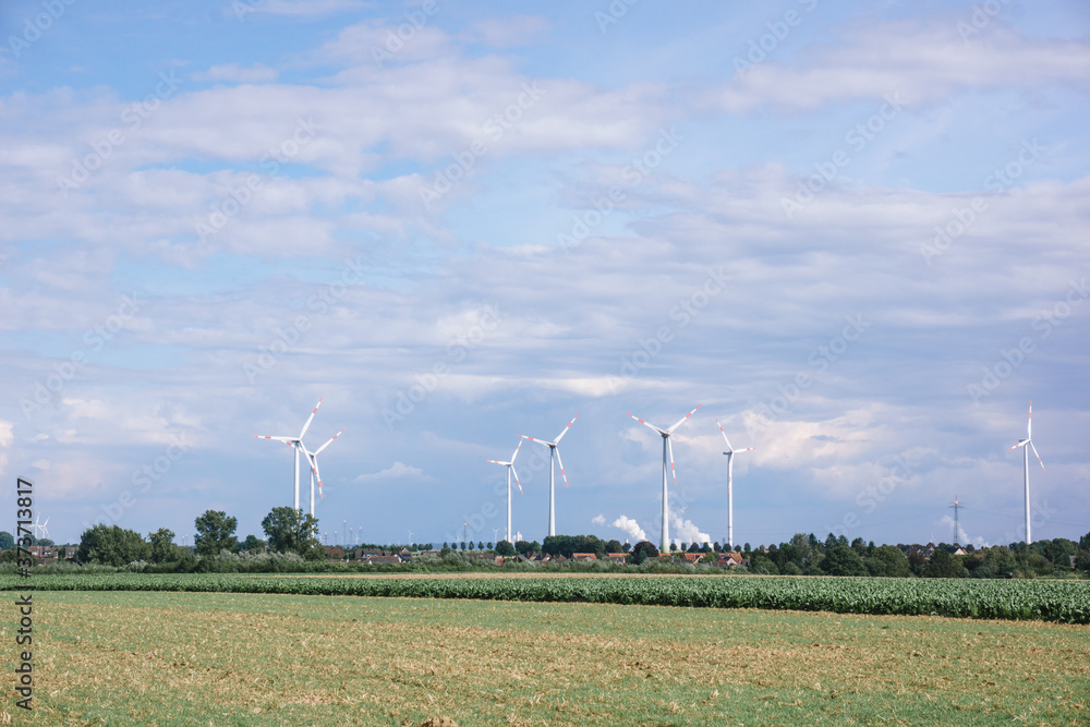 Windmills near the village. Windmills in the autumn field. Windmills near the village. Windmills in the autumn field.