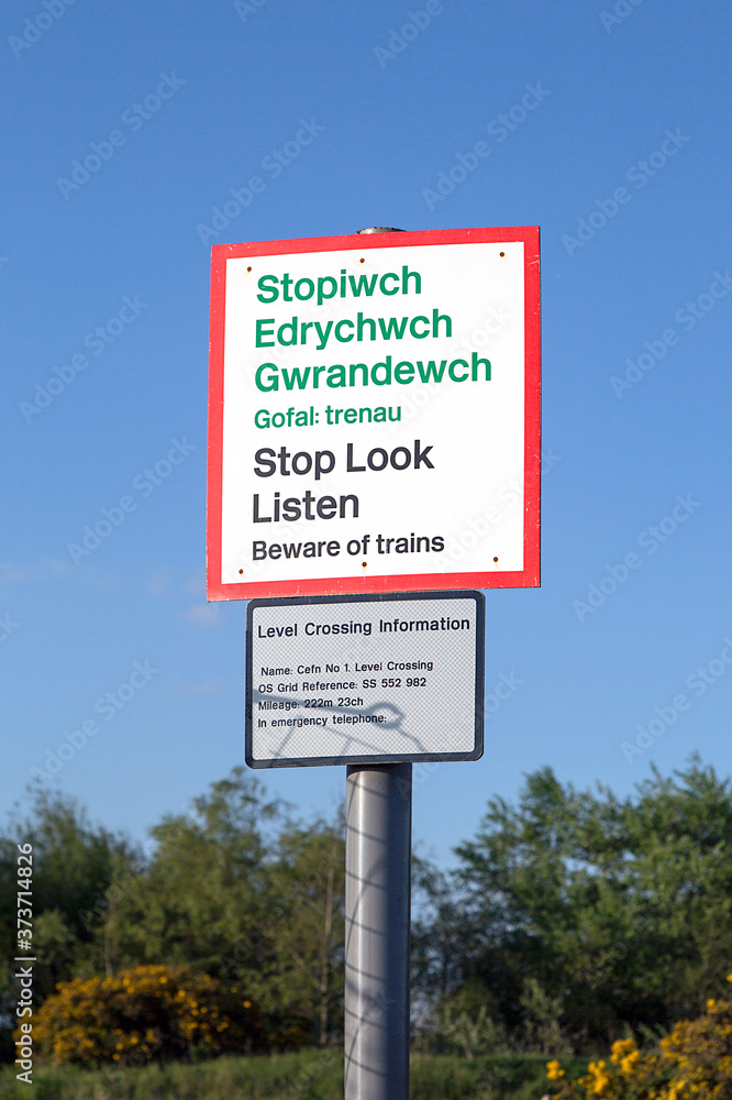 Warning sign on a railway pedestrian level crossing - UK Stop, Look, Listen for oncoming trains. 