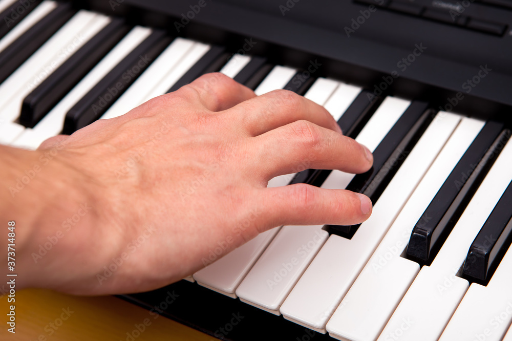 Fototapeta premium Hand and Piano Keyboard