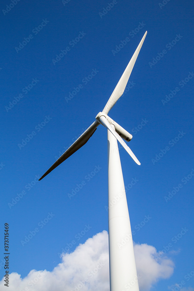 Single wind turbine with blue sky background from directly below in a vertical format - UK Single wind turbine with blue sky background from directly below in a vertical format - UK