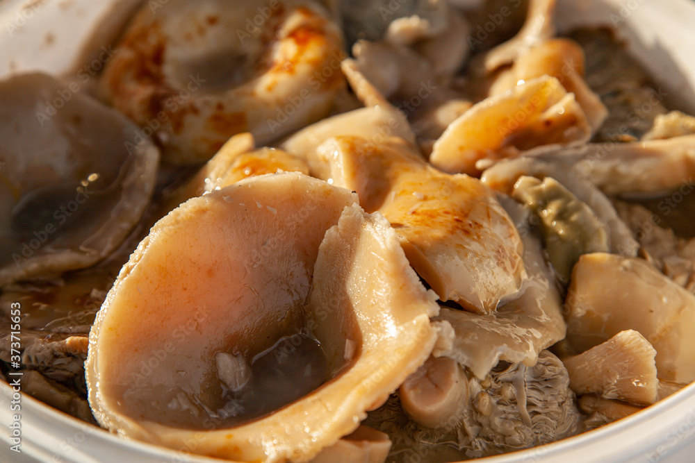 Altai salted mushrooms gruzd - milk mushroom in a plastic bucket at the fair Altai salted mushrooms gruzd - milk mushroom in a plastic bucket at the fair