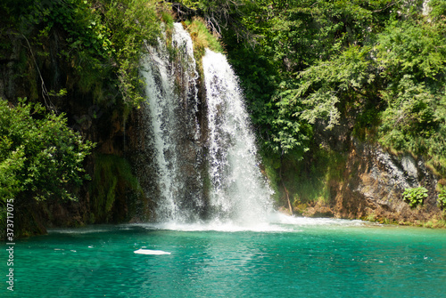 Waterfall and turquoise lake © katspi