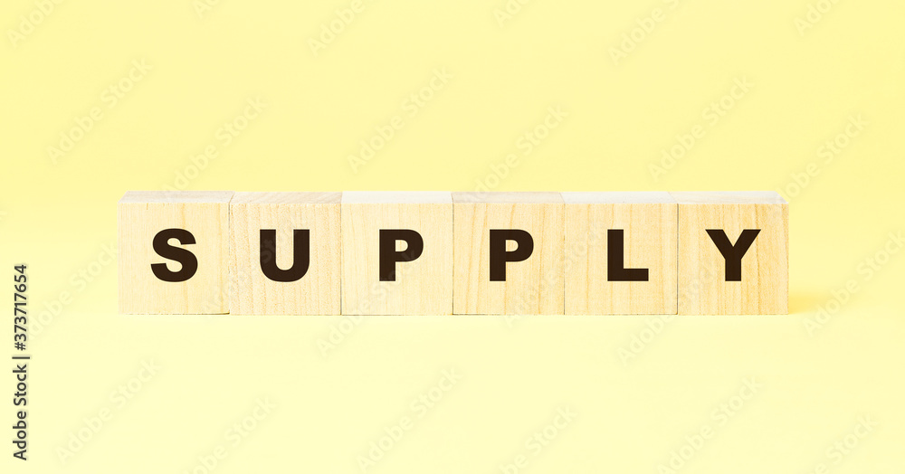 word supply made with wooden cubes on yellow background word supply made with wooden cubes on yellow background