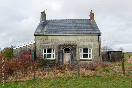 Small double fronted, abandoned farmhouse cottage in a remote location in Wales. Double fronted detached property in need of renovation.