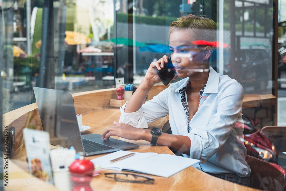 Business woman working behind glass stock photo Business woman working behind glass stock photo