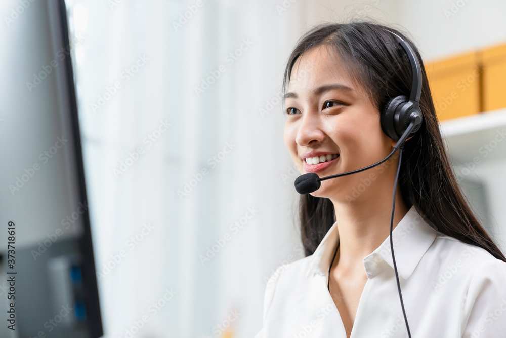 Asian business woman wear headset and working on telemarketing with online customer support. Asian business woman wear headset and working on telemarketing with online customer support.