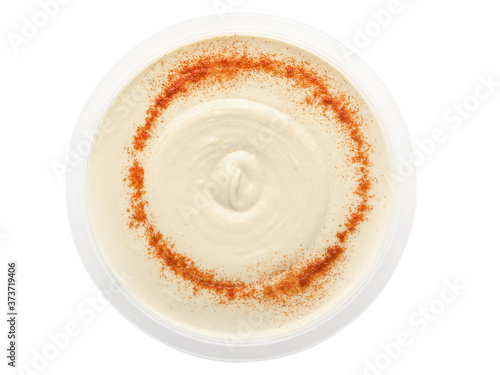Fresh hummus with paprika in a transparent plastic bowl isolated on a white background. Design element for product label, catalog print, web use. Top view. Flatlay.