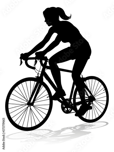 A woman bicycle riding bike cyclist in silhouette