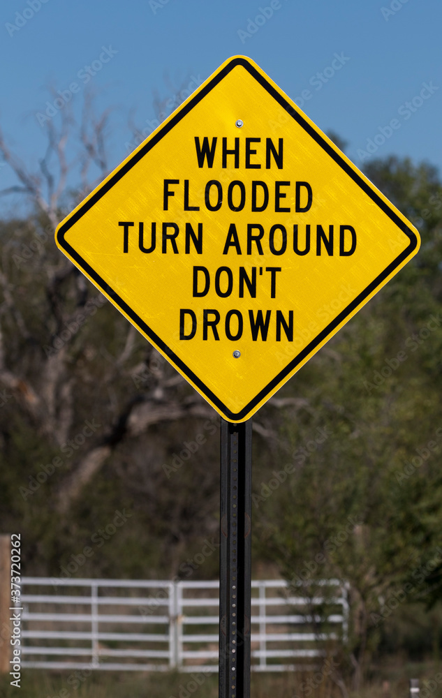 Flash flood sign says When Flooded Turn Around Do Not Drown 