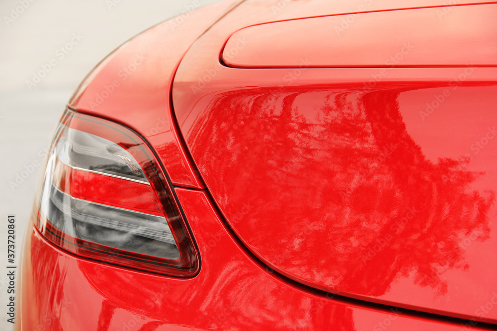 Naklejka Car headlights. Luxury Headlights. Part of a red car close up. Bumper