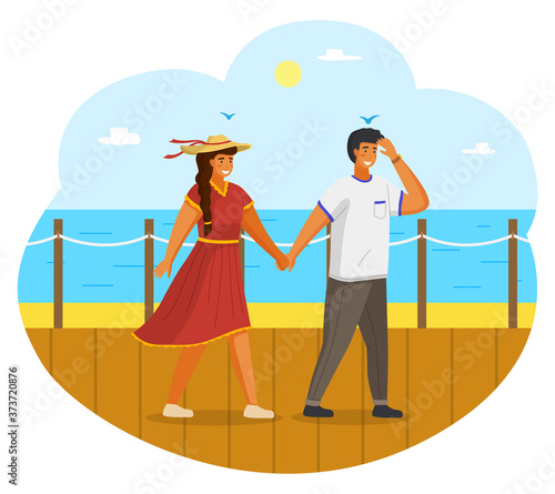 Couple walking together on the seashore. Young guy and girl wearing a light dress and a straw hat holding hands walking on the seafront sunny day. Man and woman meeting in summer vacation