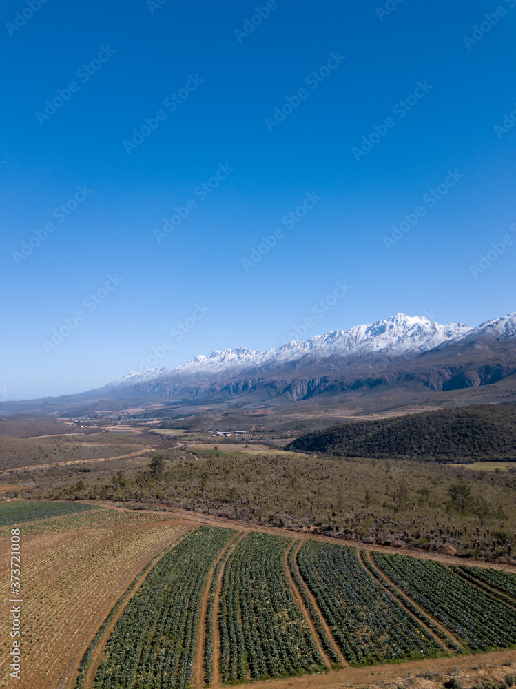 Portrait photo of the Swartberg Mountains with snow covered on the peaks.  Photo taken in Oudtshoorn, Western Cape, South Africa