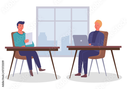 Businessmen dressed in formal clothes are sitting at the table with laptop and talking. Office workers discussing matters. Business meeting and consideration of working issues. Friendly team work