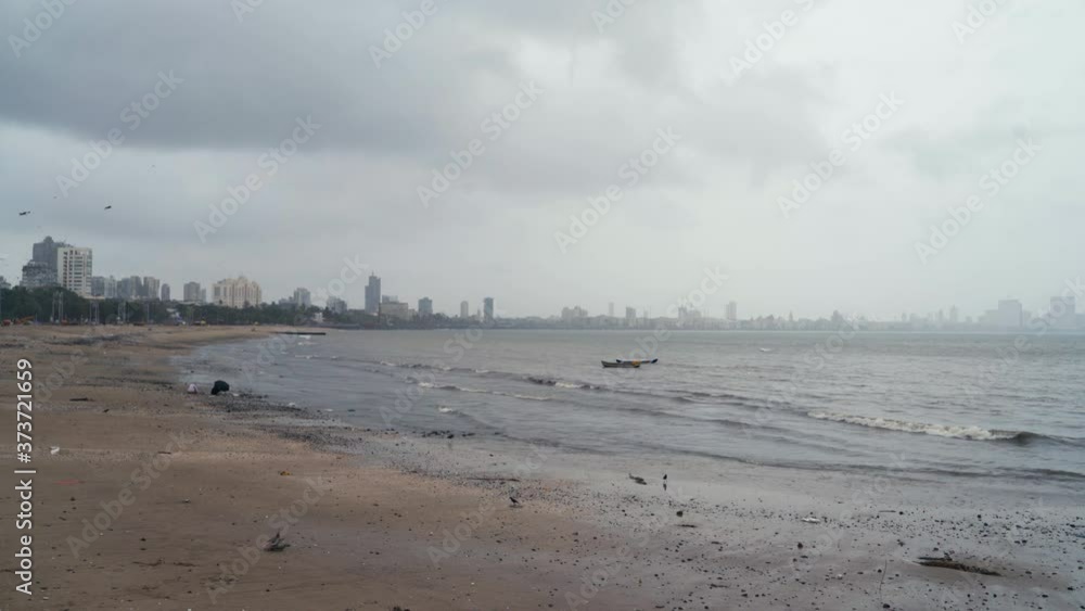 Birds Flying Over The Girgaum Chowpatty Beach In Mumbai. Deserted Due To Coronavirus Lockdown In India - wide shot Birds Flying Over The Girgaum Chowpatty Beach In Mumbai. Deserted Due To Coronavirus Lockdown In India - wide shot