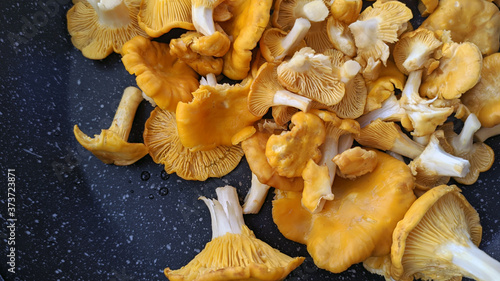 photo of chanterelle mushrooms on a black teflon frying pan