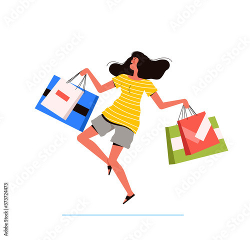 Young shopping woman holds packages from the store in her hands and jumps happily. The concept of a successful purchase and the joy of discounts