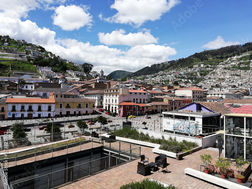 Historic Center of Quito with views of mountains and houses. Image taken overlooking the avenue 24 de mayo and its boulevard. In the background mountains during a sunny day