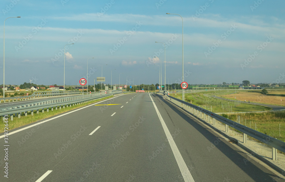 Fototapeta premium A road sign on a highway with a speed limit